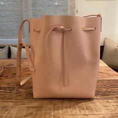 New With Tags! Pale Pink All Leather Mansur Gavriel Bucket Bag. Very Sweet, Understated Shade Of Pink. Comes With A Detachable Matching Mini Pouch And Dust Bag. Product Details: Made In Italy Adjustable And Detachable Shoulder Strap Drawstring Opening Height: 12.5in / 31.5cm Length: 9.75in / 25cm Depth: 7.5in / 19cm Strap Drop: 19in / 48cm Pink Leather Rectangular Bucket Bag, Pink Rectangular Leather Bucket Bag, Rectangular Pink Leather Bucket Bag, Elegant Pink Pouch Bucket Bag, Pink Leather Shoulder Bag With Dust Bag, Elegant Pink Tote Bucket Bag, Pink Leather Bucket Bag For Daily Use, Modern Pink Bucket Bag With Detachable Strap, Pink Bucket Bag With Dust Bag Included