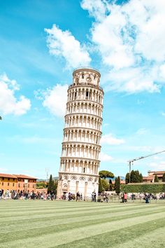 the leaning tower of pisa in italy with people walking around and onlookers