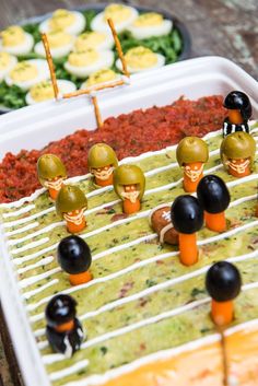 a football game made out of fake olives and black olives on a tray