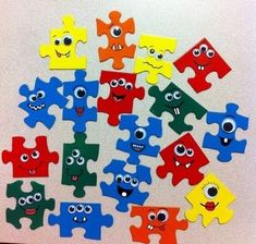 a pile of colorful puzzle pieces with faces on them