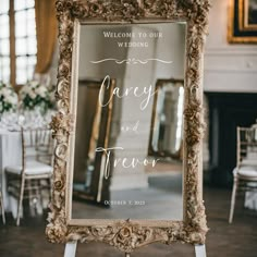 a sign that says welcome to our wedding is displayed in front of a large mirror