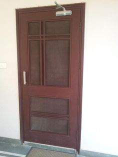 a red door with mesh screen on the front and side panels, in an empty room