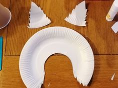 the paper plate is cut out and placed on the table