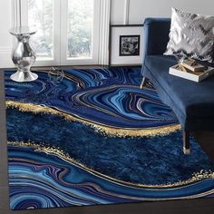 a living room with blue and gold rugs on the floor next to a couch