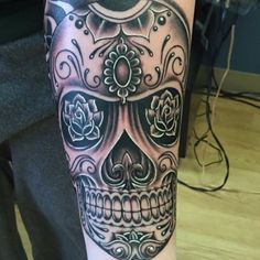 a man with a skull tattoo on his leg