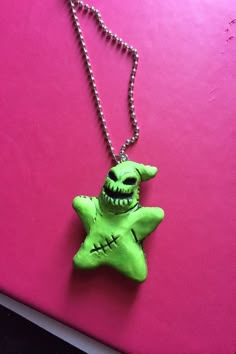 a necklace with a green zombie face on it