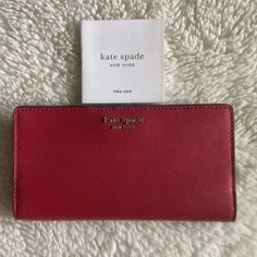 - Brand New, 100% Original Kate Spade - Genuine Saffiano Leather - 11 Card Slots - 1 Clear View Id Card Slot - Exterior Back Pocket For Change - 4 Interior Compartment For Bills And Receipts - Kate Spade Signature Metal Logo On The Front Red Bifold Evening Bag, Kate Spade Everyday Bifold Bag, Red Kate Spade Wallets For Everyday Use, Classic Kate Spade Bags With Card Slots, Kate Spade Formal Bags With Card Slots, Elegant Red Wallet For Everyday Use, Elegant Red Everyday Wallet, Kate Spade Disney, Gold Wallet