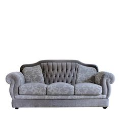 a gray couch sitting on top of a white floor