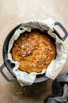 a loaf of bread sitting in a pot on top of a table