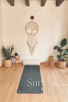 there is a yoga mat on the floor in front of a wall with a dream catcher hanging from it