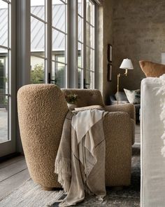 a living room filled with furniture and lots of windows