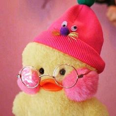 a yellow duck wearing glasses and a pink hat