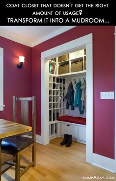 a room with red walls and white closets filled with coats, clothes and shoes