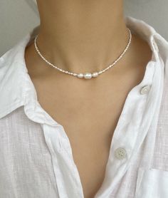 "The main photo shows the 14\" option.  Freshwater pearls are one of a kind so will differ slightly from those shown in the photos. ∙  S I Z E ∙ G U I D E ∙ The below is a rough size guide for adults. We recommend taking your own measurement first before purchasing to ensure the perfect fit, however, exchanges are always welcome - please see our Shop Policies.  14\" - choker length 16\" - collarbone length  18\" to 20\" - upper chest length  Each necklace comes with an additional 2\" extension chain, for example, if you select the 14\" option, the total length of the necklace including the extension chain will be 16\".   M A T E R I A L S ∙    Durable steel cord, genuine freshwater pearls, silver plated or sterling silver clasp and extension chain.  ∙ C A R E ∙  Avoid contact with water or Classic Silver Beaded Necklaces With Pearl Pendant, Silver Necklace With Sterling Silver Clasp And Baroque Pearl, Silver Classic Beaded Necklace With Pearl Pendant, Sterling Silver Necklaces With Pearl Drop And Round Beads, Adjustable Silver Beaded Necklaces With Pearl Drop, Silver Necklaces With Pearl Charm And Round Beads, Sterling Silver Necklace With Pearl Drop And Round Beads, Pearl White Single Strand Sterling Silver Necklace, Silver Necklace With Pearl Charm And Round Beads