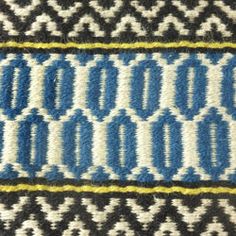 a blue and white rug with an interesting design on the bottom part of it's border