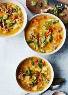 three bowls of soup with meat and vegetables