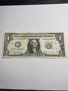 the united states of america one dollar bill is displayed on a white surface with black frame