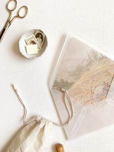 a pair of scissors sitting on top of a table next to some pictures and other items