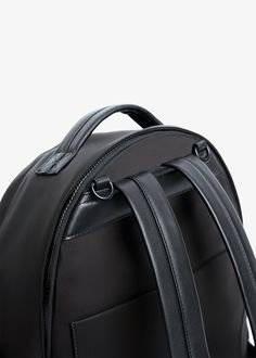 the back view of a black backpack with two straps on each side and an external compartment