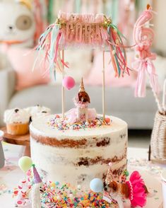 a birthday cake with an unicorn on top