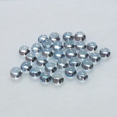 several shiny silver colored objects on a white surface