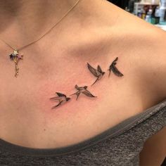 a woman's chest with three birds on it