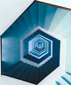 an image of a spiral staircase going up to the sky with blue and white colors