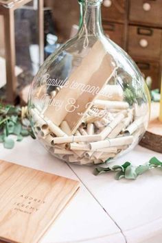 a vase filled with matches sitting on top of a table next to a wooden box