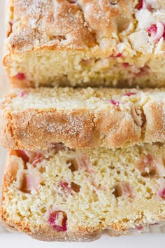 two slices of strawberry bread are stacked on top of each other with powdered sugar