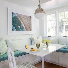 a dining room table with two benches and a vase on the table next to it