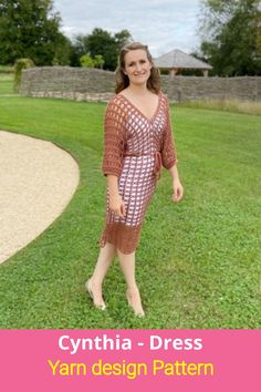 a woman standing in the grass wearing a dress with an openwork pattern on it