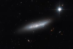 an image of a spiral galaxy in the dark night sky with stars and bright lights