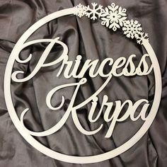 a sign that says princess kripa in white lettering on a black satin background