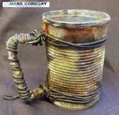 an old metal mug with a twisted handle