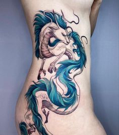 a woman's stomach with a dragon tattoo on the side, and blue hair