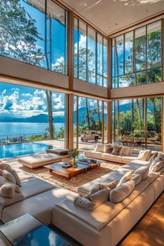 a living room with large windows overlooking the water