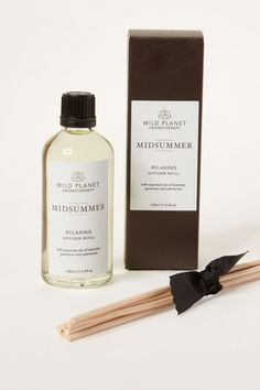 Midsummer Diffuser Refill next to reed sticks and branded black box by Wild Planet Aromatherapy Luxury Diffuser, Palmarosa Essential Oil, Vegan Candles, Floral Scent, Lavender Oil, Room Spray, Pure Essential Oils, Geraniums, Home Fragrance