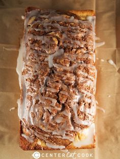 a loaf of bread covered in icing and nuts