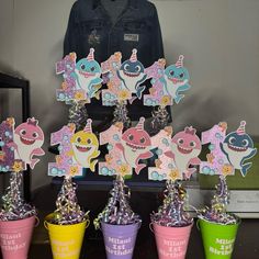 there are many cupcakes that have been placed in buckets on the table