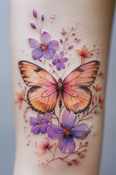 a butterfly tattoo on the side of a woman's leg with purple flowers and butterflies around it