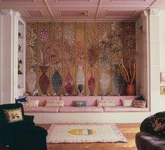 a living room filled with lots of furniture next to a wall covered in vases