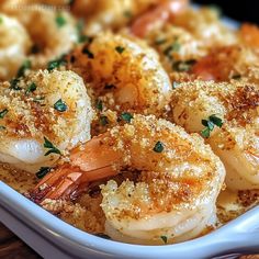 cooked shrimp with parmesan bread crumbs in a white dish