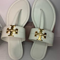 Gold Logo With White Leather Material Sz 7 Luxury Leather Flip Flops With Single Toe Strap, Luxury Leather Flip Flops For Beach, Designer Sandals With Gold-tone Hardware, Elegant Tan Sandals With Leather Lining, Elegant White Sandals With Leather Footbed, Luxury Leather Open Toe Flip Flops, Designer Toe Post Sandals, Elegant Leather Flip Flops For Vacation, Luxury Tan Sandals With Leather Footbed