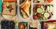 several plastic containers filled with different types of food and vegetables, including bread, salad, fruit, and veggies