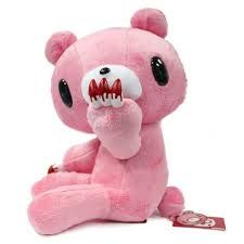 a pink stuffed animal with teeth on it's face and mouth wide open, sitting in front of a white background