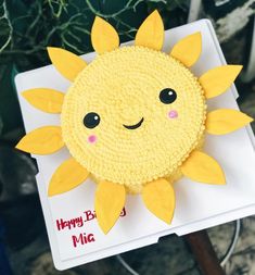 a cake decorated to look like a smiling sun