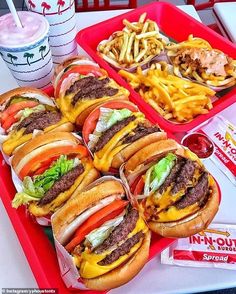 a tray filled with lots of hamburgers and fries