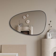 a mirror hanging on the wall above a fireplace