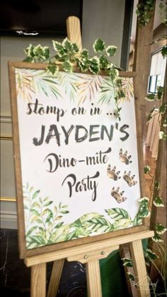 a sign that says stamp on jayden's fine - mitt party in front of a wooden easel