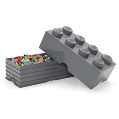 a gray lego box with several different colored blocks in the bottom and one is open